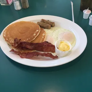 a breakfast of pancakes, bacon and eggs