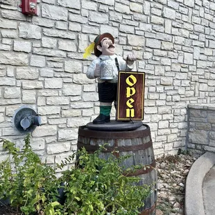 a statue of a man holding a sign