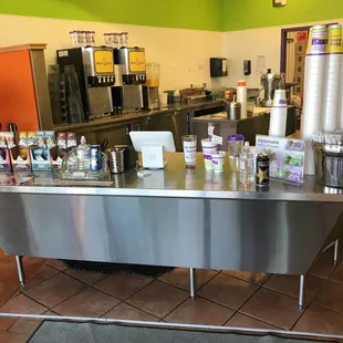 a large stainless steel counter in a coffee shop