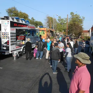  large crowd of people standing in a parking lot