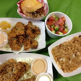 Meal from Sam Choy's - Clockwise from top - BBQ Pork Sandwich, Ahi Poke, Firecracker Rice, Pork Belly Fries, Chicken Snake bites