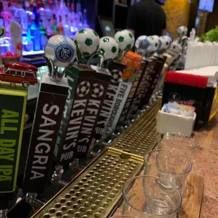 a row of beer glasses on a bar