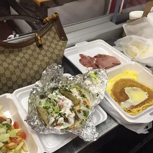 Chili cheese fries , steak tocos , pancakes ham grits egg and a Gucci bag