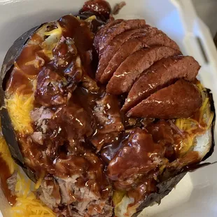 Loaded baked potato with chopped brisket and sausage