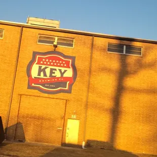 a brick building with a sign for key brewing