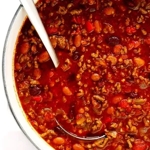 a bowl of chili with a spoon