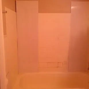 repairing hole in bathtub with plastic-lined wall