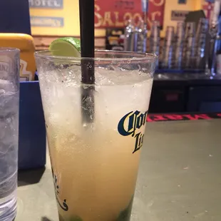 a cold drink with a lime wedge
