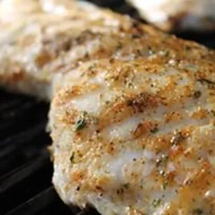 two chicken breasts on a grill