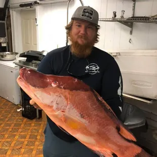a man holding a large fish