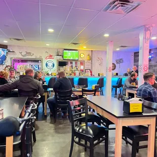 people sitting at tables in a restaurant