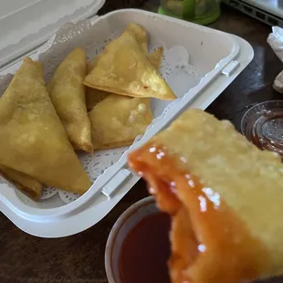 a hand holding a piece of food