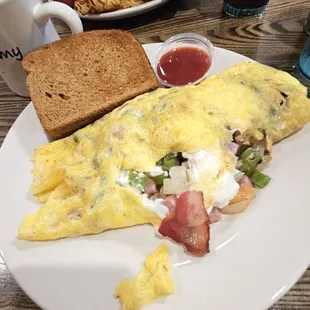 Custom omelet filled with cream cheese, green peppers, ham, bacon, onion.