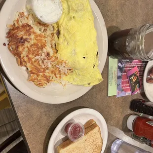 Greek omelette with hash browns along with side of sourdough toast with their strawberry jam.