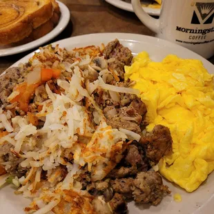 a plate of eggs, sausage and hash browns