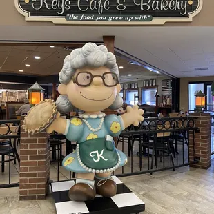 a statue of a woman holding a baseball glove