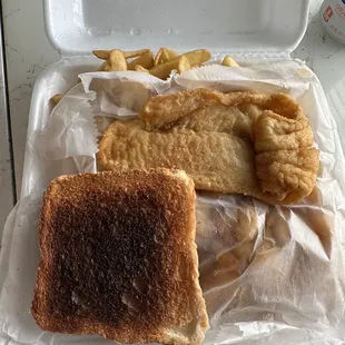 Greasy Shrimp and fish plate with burnt burnt toast.