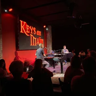 a man playing a grand piano