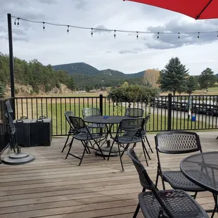 a patio with chairs and an umbrella