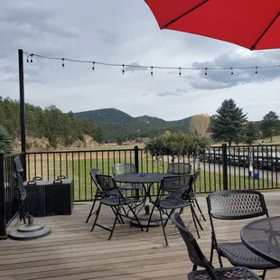 a patio with chairs and an umbrella