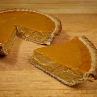 a slice of pumpkin pie with a bite taken out of it