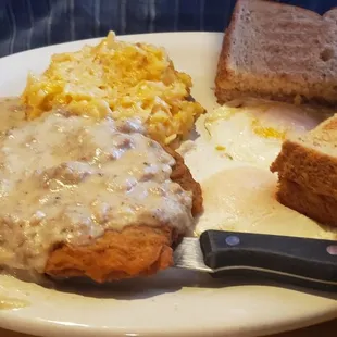 Country fried steak,  cheesy hash browns,  eggs over easy,  wheat toast