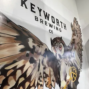 an owl holding a key