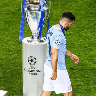 a man walking past a trophy