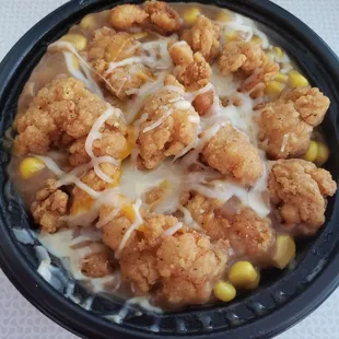 KFC Famous Bowl - Mashed Potatoes, Gravy, Popcorn Chicken, Corn, and Shredded Cheese all together to make one amazingly delicious bowl.