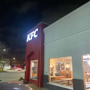 the front of a kfc restaurant at night