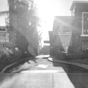 a black and white photo of a person walking down a street