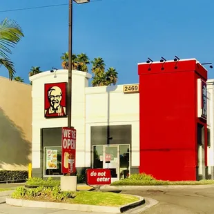 a red and white building and palm trees