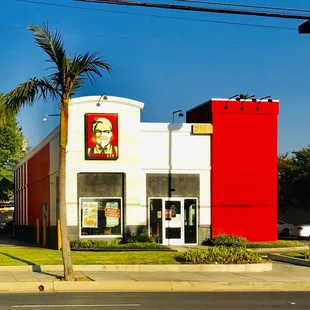a red and white building with a large picture of kfc on the side of the building