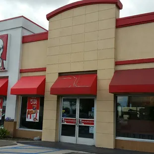 Store front with small parking lot in the front.