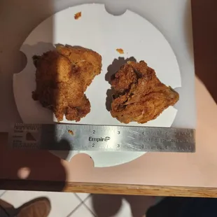 I'm never button chicken from this location again. I bought a six piece bucket... and look at what counts as TWO pieces!! Those are NUGGETS