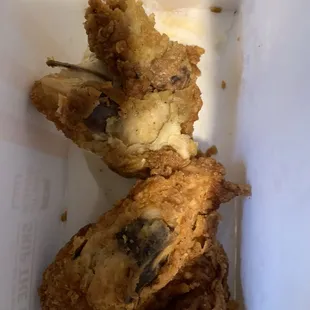 A chicken that looks like it was come from a garbage can.