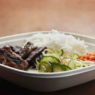 KFIRE BBQ Plates come with your choice of delicious protein and two sides. Rice and green onion salad are included.