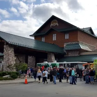 a crowd of people standing in front of a restaurant