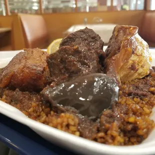 Thiebu Djeun, the Senegalese national dish: fried rice, fresh tomato, plantain, yam, and cabbage on a fish stew base.