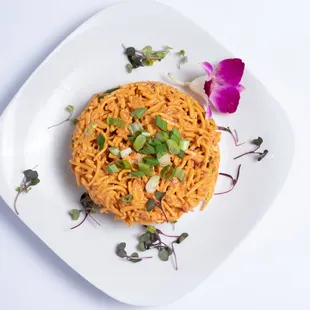 a plate of food with a flower