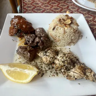 Lamb kebab, chicken kebab, and kefta kebab with butter rice pilaf topped with toasted almonds and pine nuts