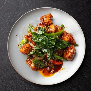 Khamdee Spicy Chicken Crispy chicken pieces are stir-fried with spicy garlic sauce, garlic, basil, bell pepper, green bean, and toppe basil