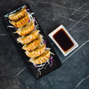 Pot sticker (6 pieces) 
Pan-fried pork and vegetable dumplings. Served with Thai ponzu sauce.