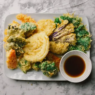 Veggie Tempura (V) 
Battered and deep-fried assorted seasonal vegetables and seaweed. Served with sweet &amp; sour sauce sprinkled with cr