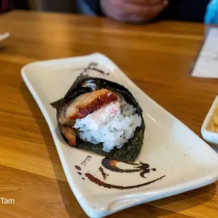 a plate of sushi and a bowl of macaroni and cheese