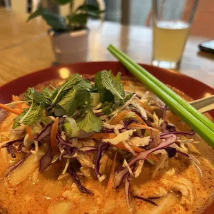 a plate of food with chopsticks