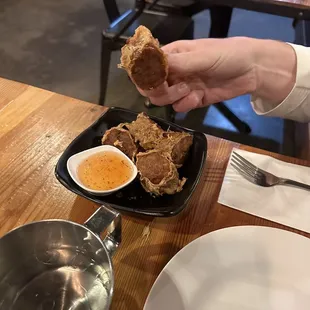 a person holding a piece of food