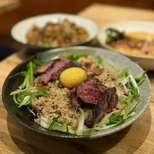 Khao Pad Mun Nuer: Beef short rib tallow fried rice w/ boneless beef short rib, scallion, fried garlic, soy-cured egg yolk | $25