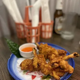 a plate of fried chicken with dipping sauce