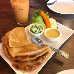 Roti with curry and cucumber salad